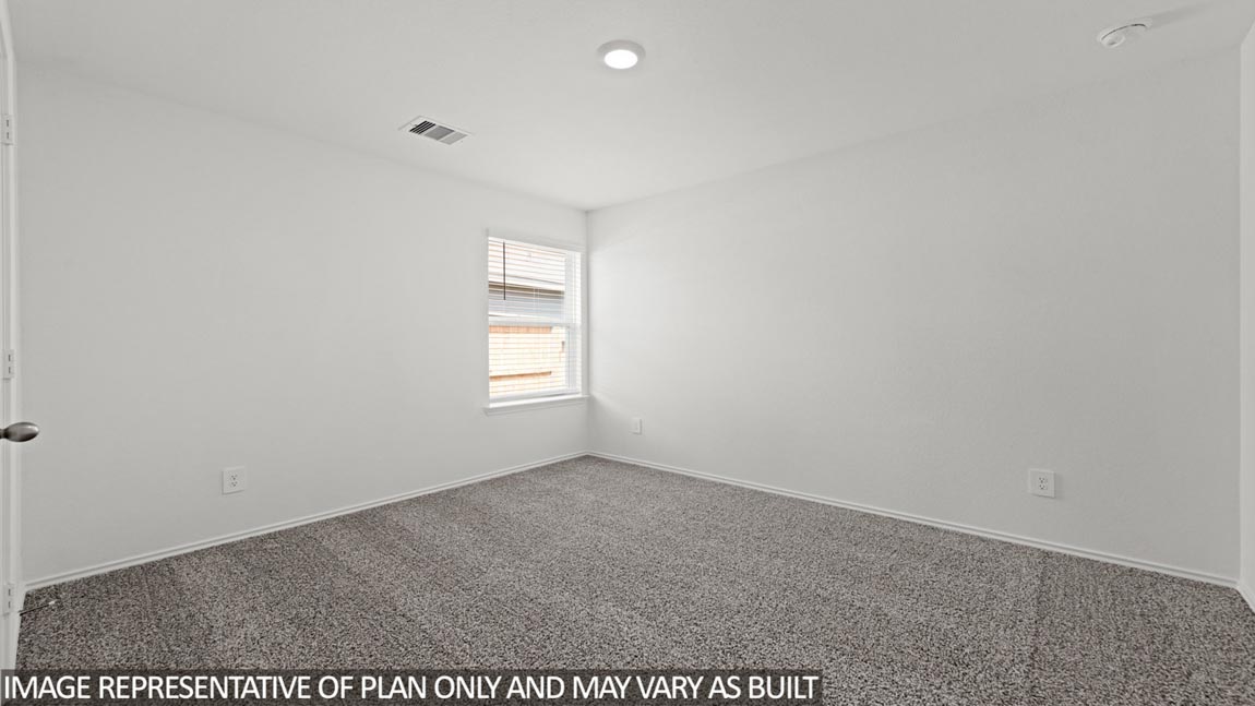 Secondary bedroom with carpet flooring