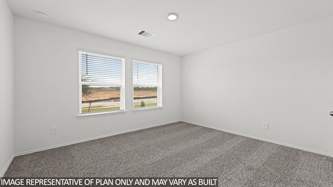 Secondary bedroom with carpet flooring