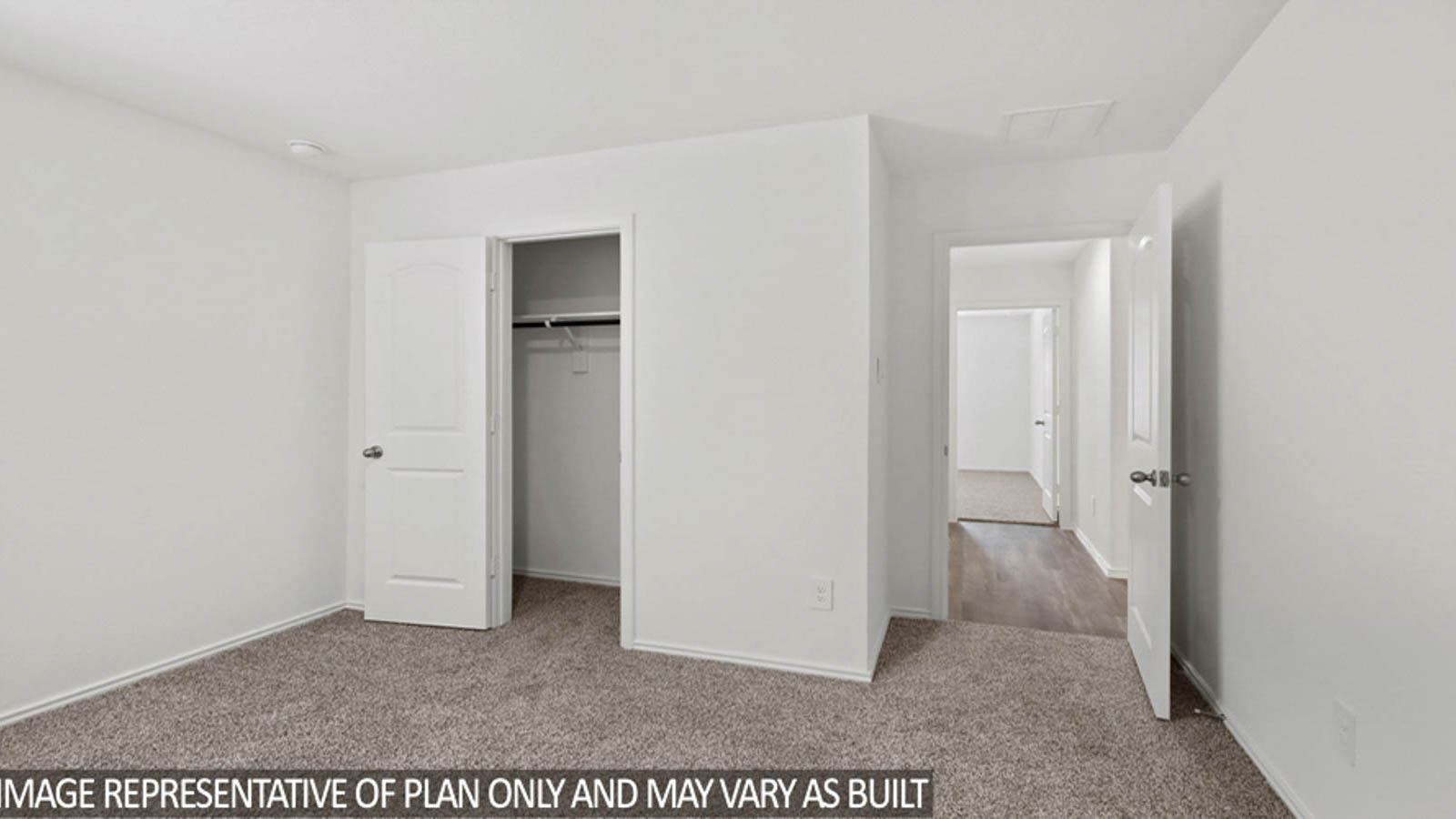 Secondary bedroom with carpet flooring and a tall closet.
