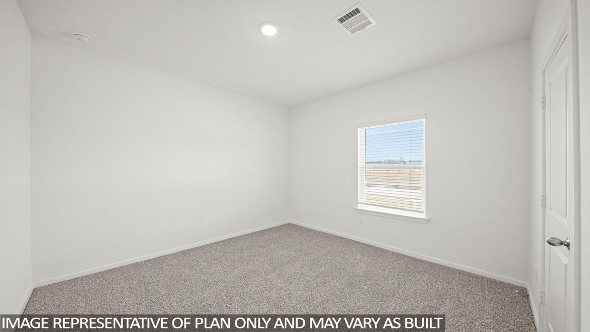 Secondary bedroom with carpet flooring