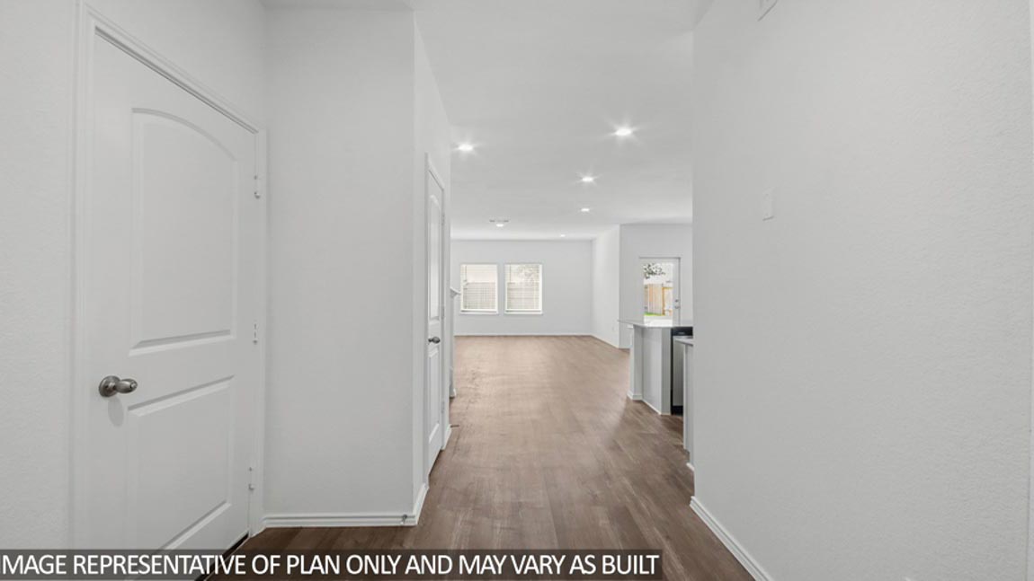 Entryway and foyer with vinyl flooring.
