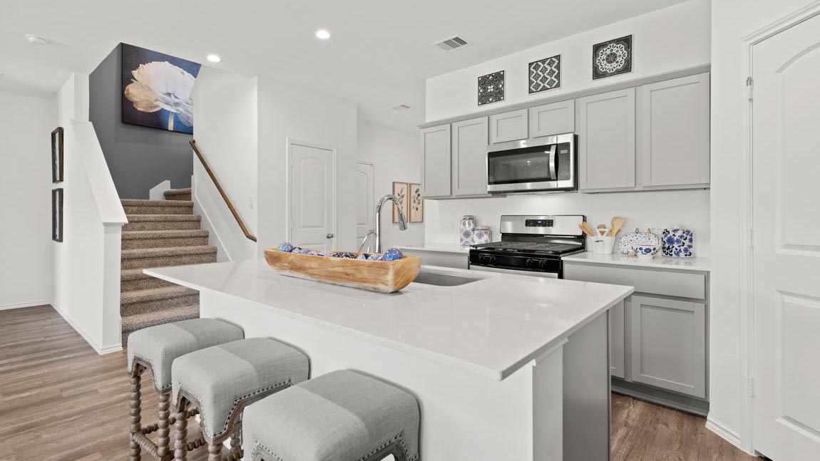 Staged kitchen with stainless-steel appliances.
