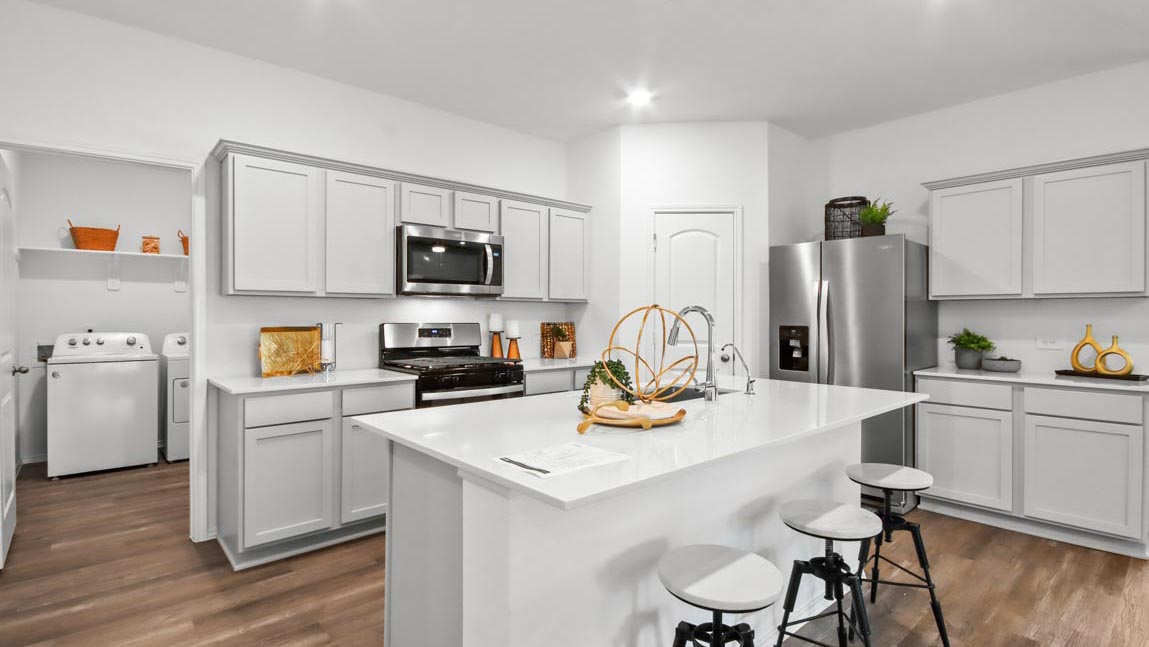 Kitchen with an island and stainless-steel appliances.