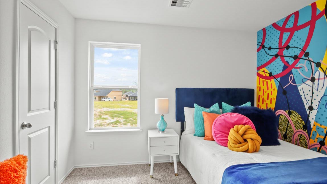 Secondary bedroom with carpet flooring and a bright window.
