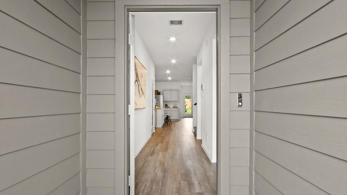 Entryway and foyer with vinyl flooring.