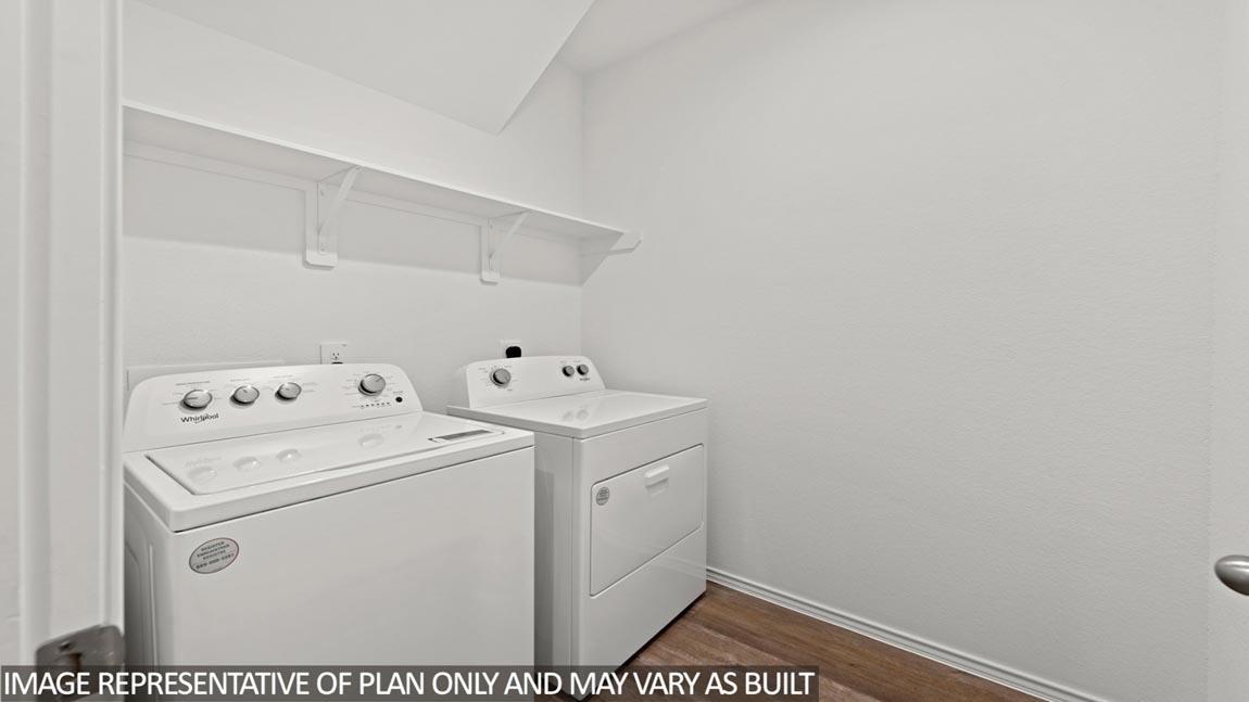Utility room with vinyl flooring and overhead storage space.