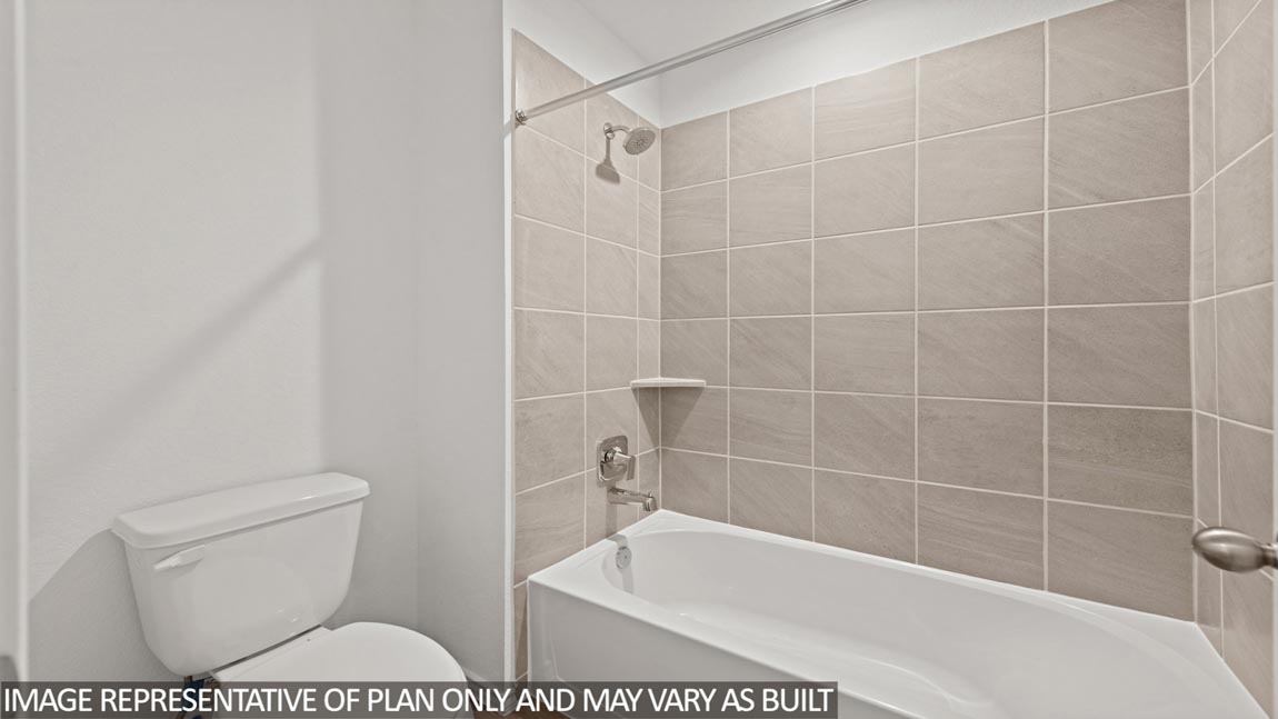 Secondary bathroom with a tile tub/shower combo and a toilet.