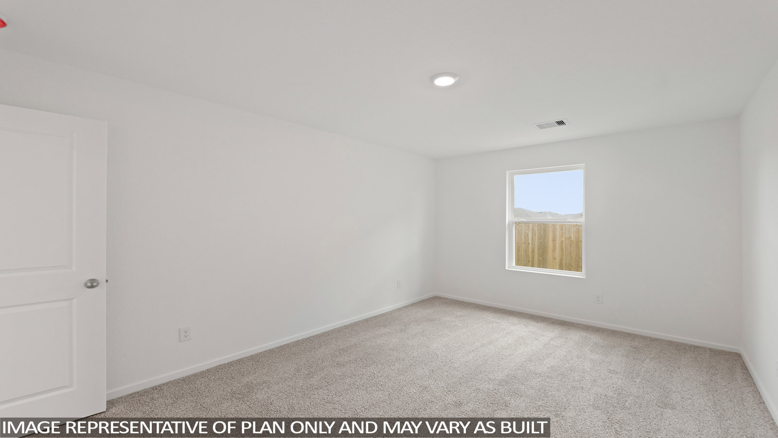 Secondary bedroom with carpet flooring