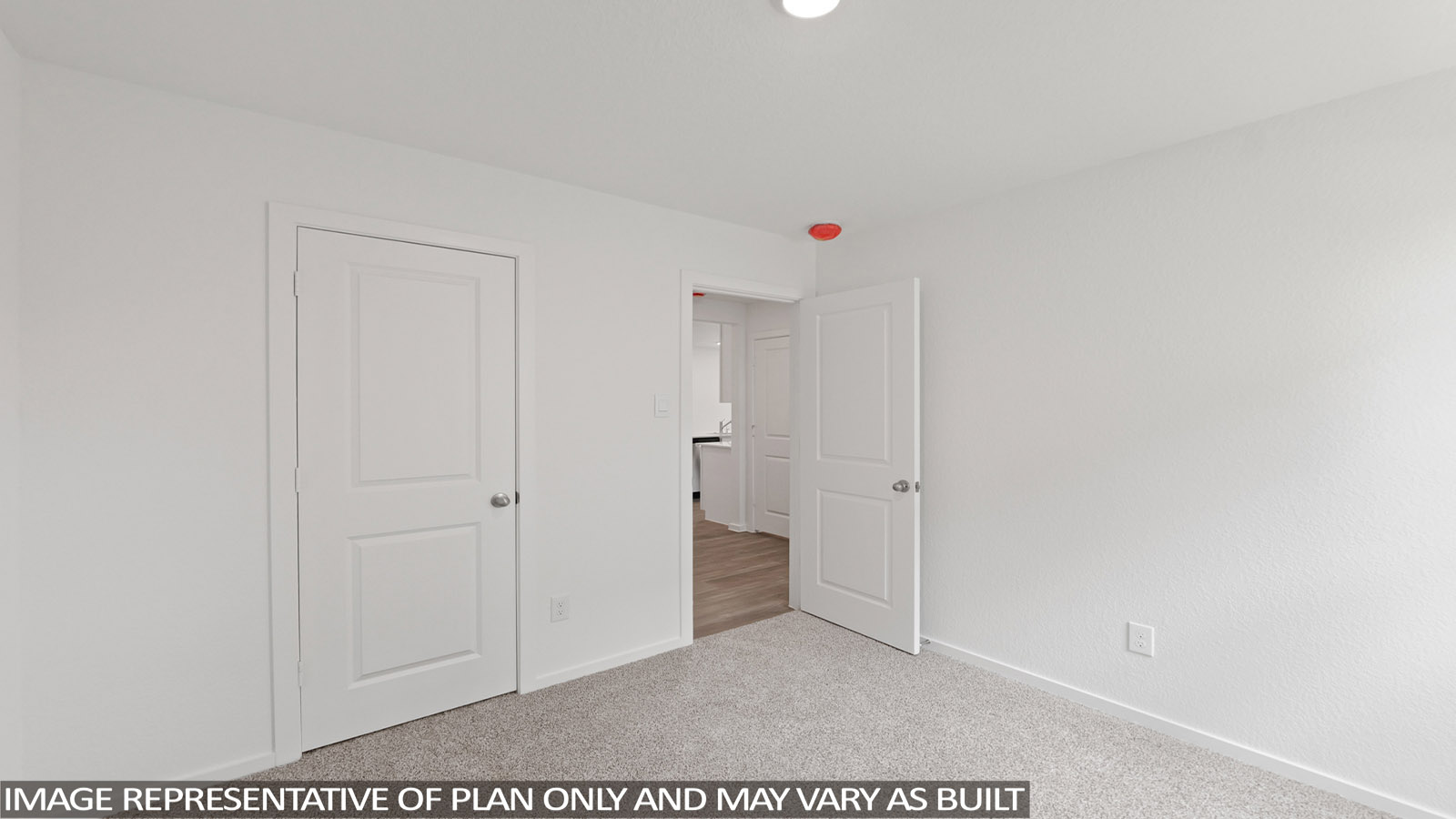 Secondary bedroom with carpet flooring
