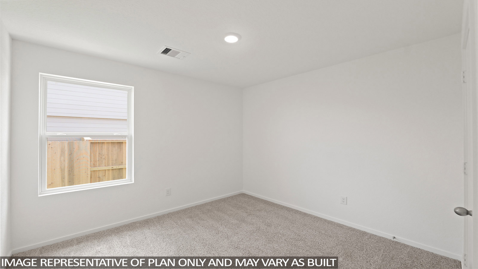 Secondary bedroom with carpet flooring