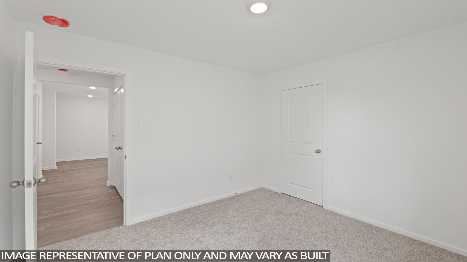 Secondary bedroom with carpet flooring