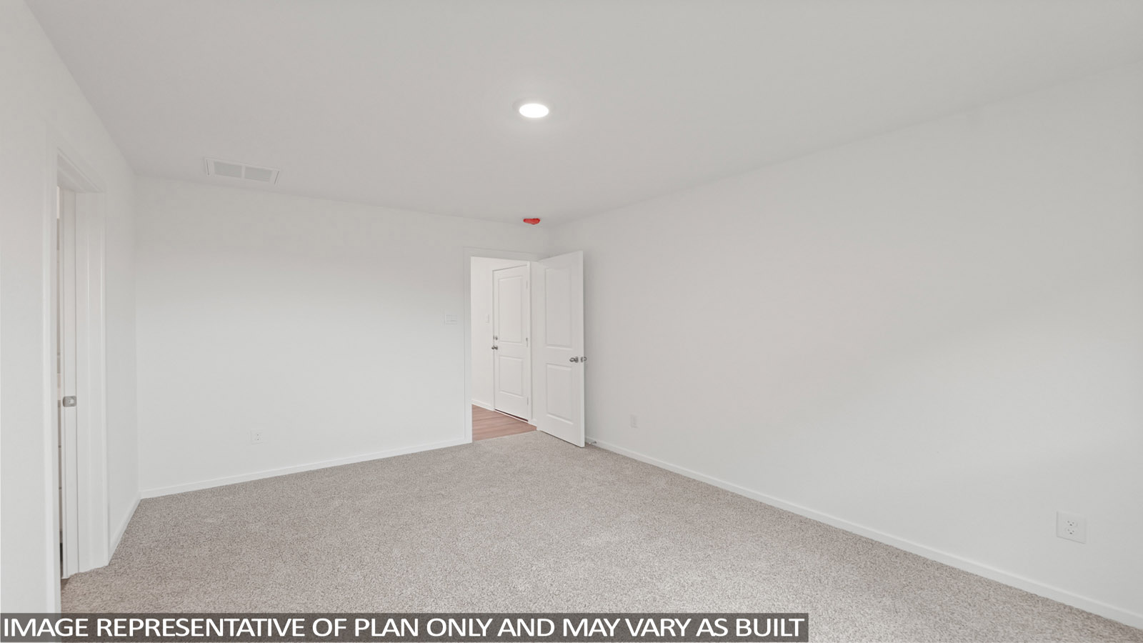Secondary bedroom with carpet flooring