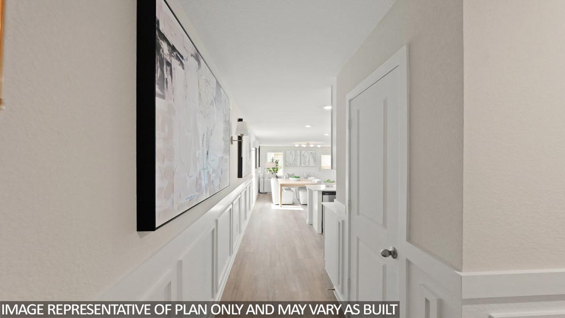 Entry hall inside the front door with clear sightline to the kitchen, living, and outdoor spaces