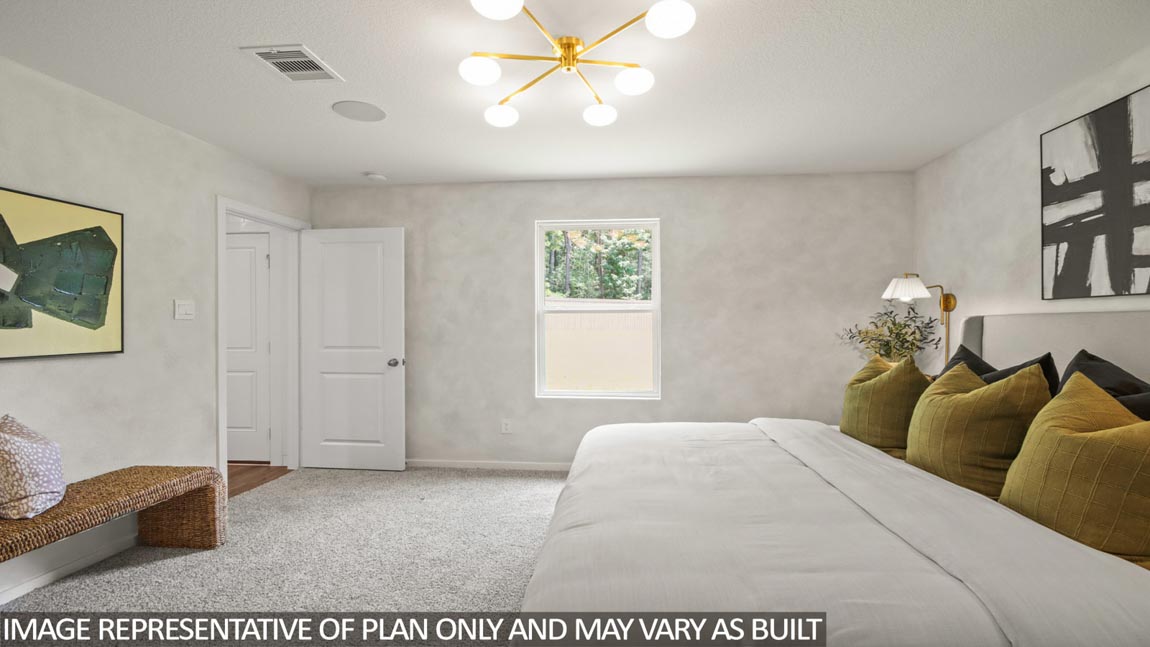 Primary bedroom with carpet flooring