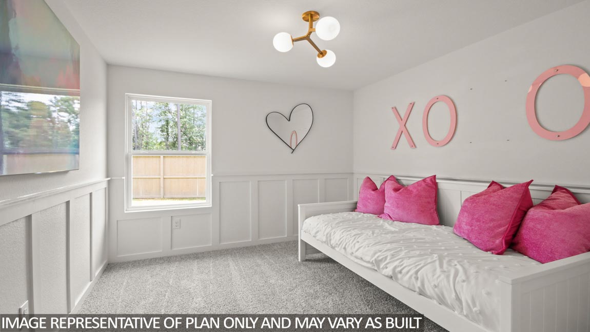 Secondary bedroom with carpet flooring