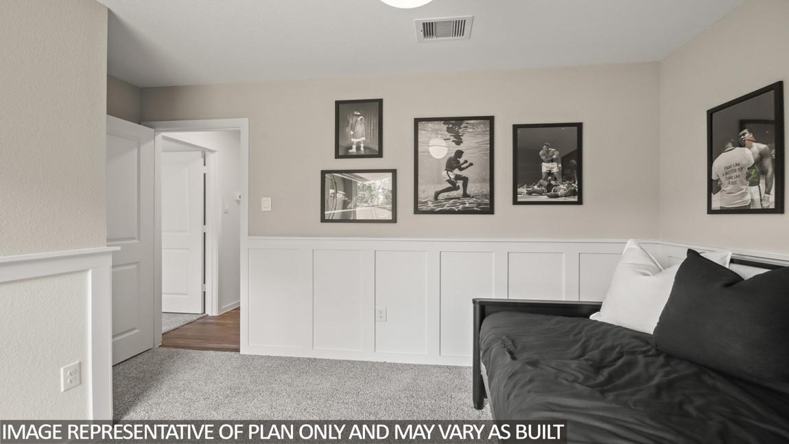 Secondary bedroom with carpet flooring