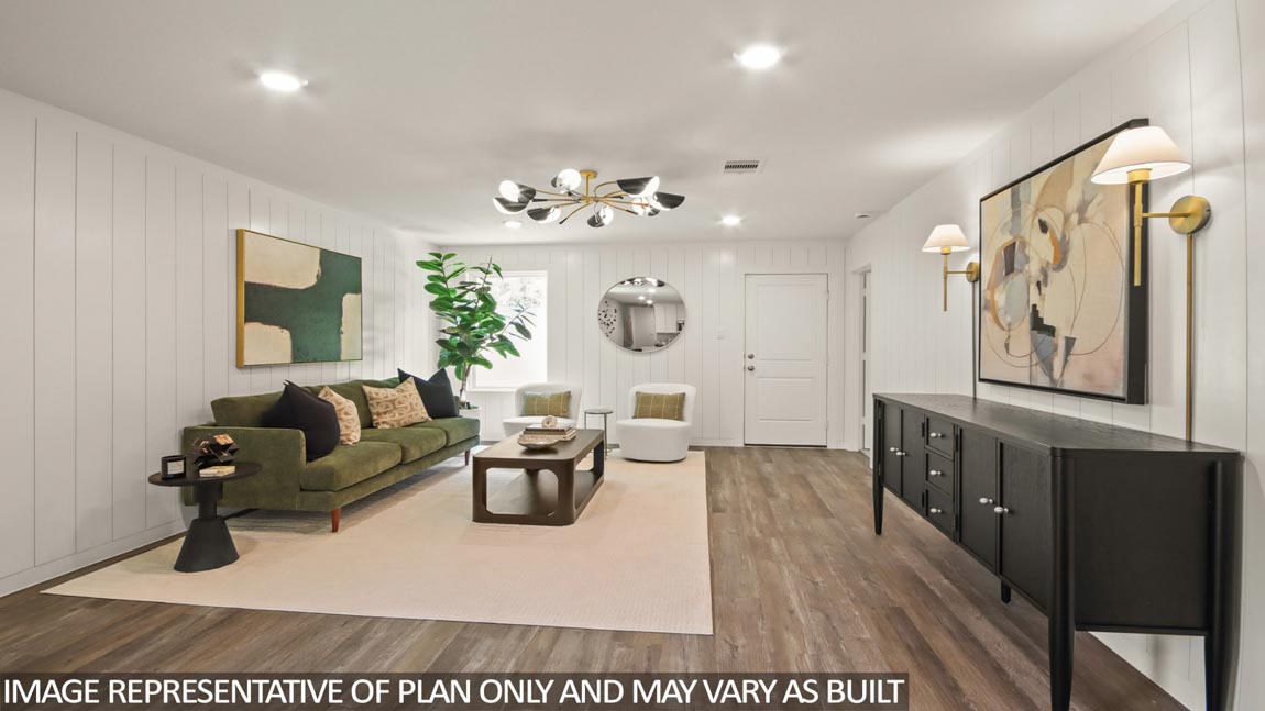 Living room with vinyl flooring and bright windows.