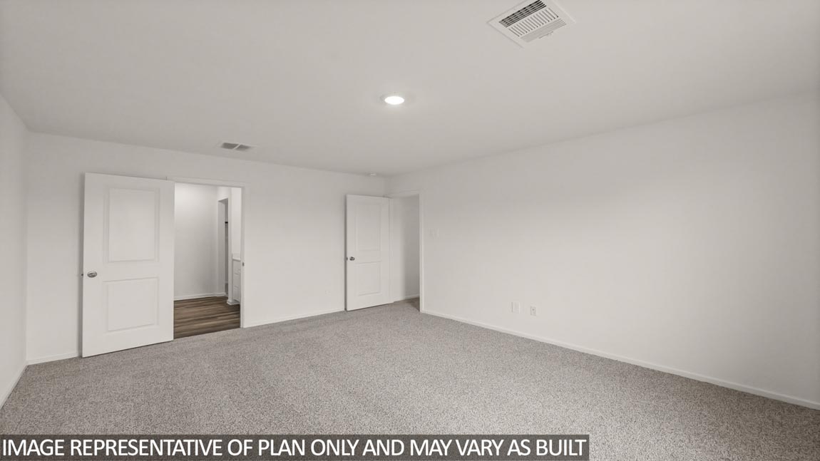 Primary bedroom with carpet flooring