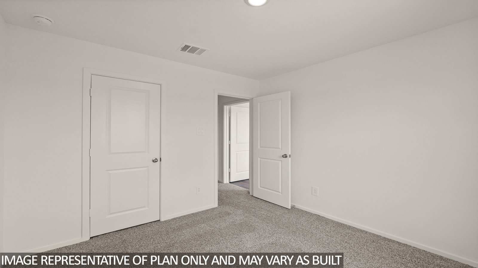 Secondary bedroom with carpet flooring