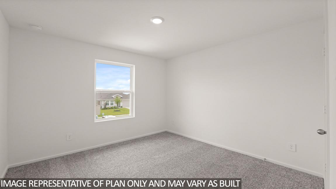 Secondary bedroom with carpet flooring