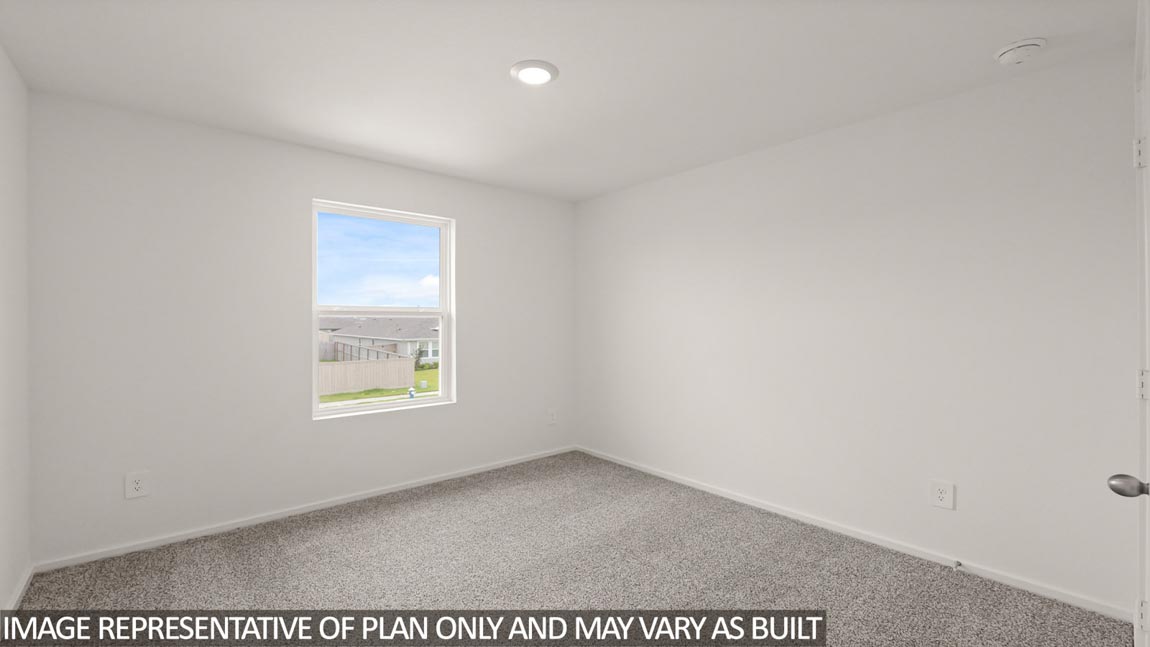 Secondary bedroom with carpet flooring