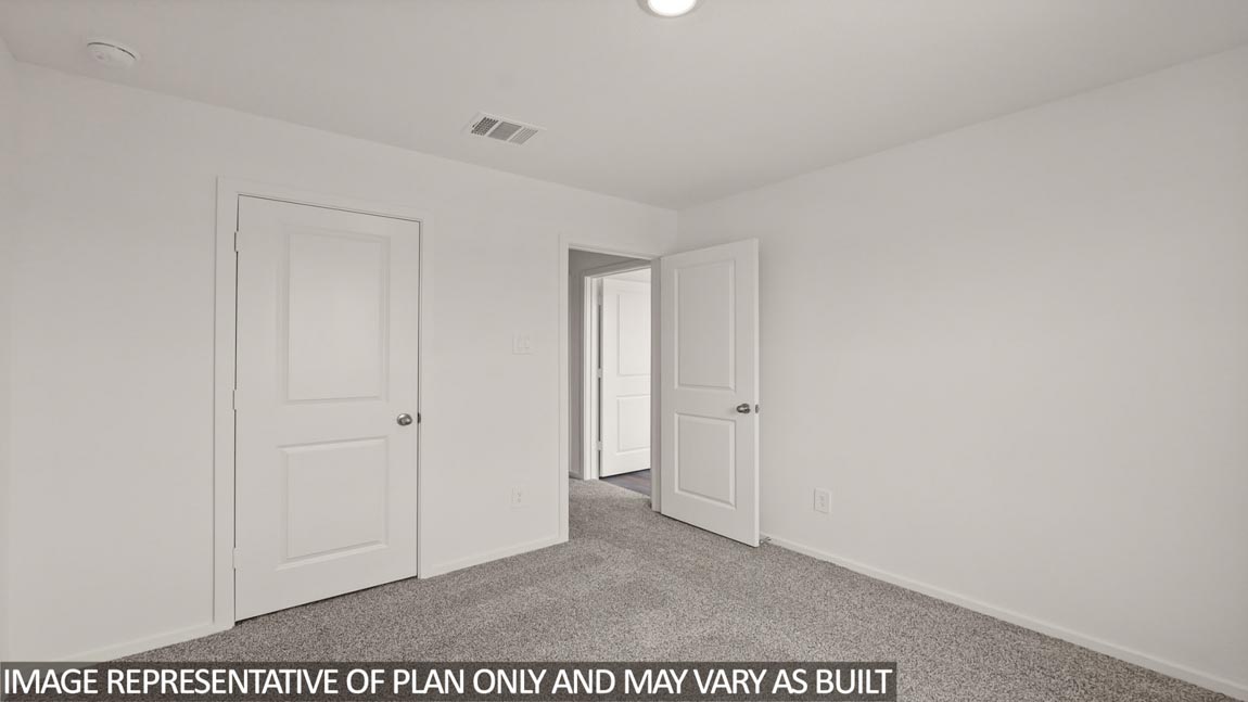 Secondary bedroom with carpet flooring