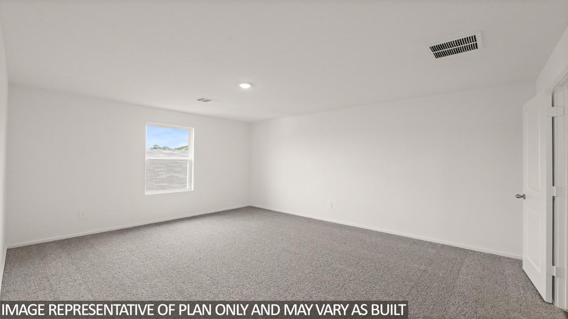 Primary bedroom with carpet flooring