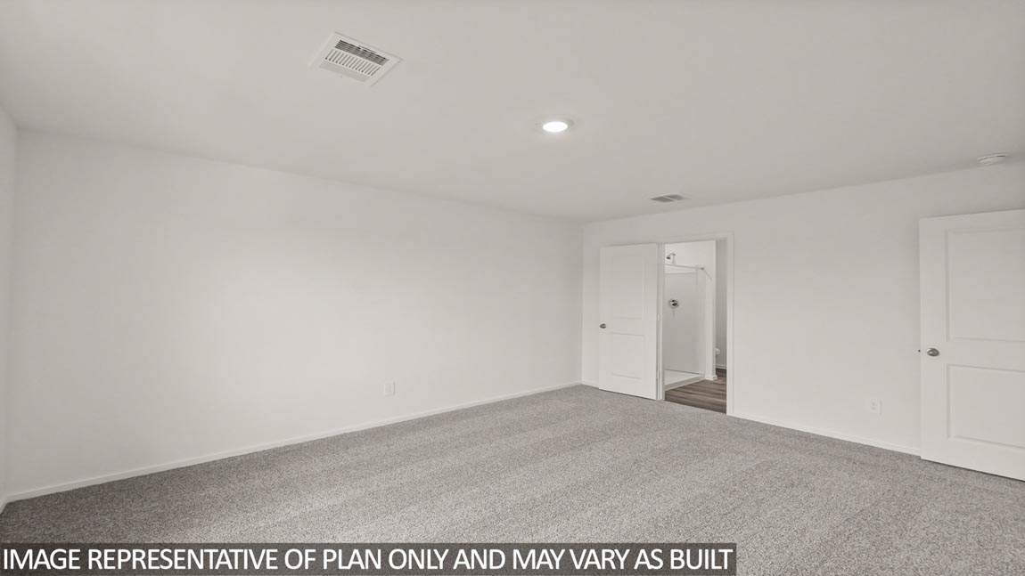 Primary bedroom with carpet flooring