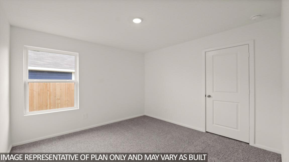 Secondary bedroom with carpet flooring