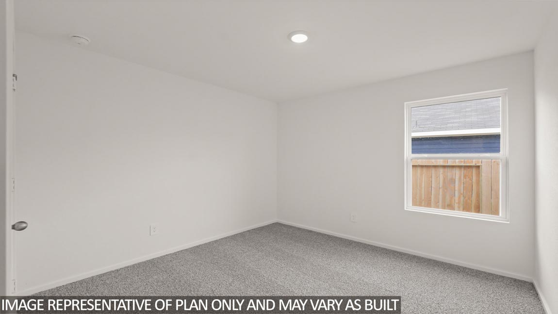 Secondary bedroom with carpet flooring