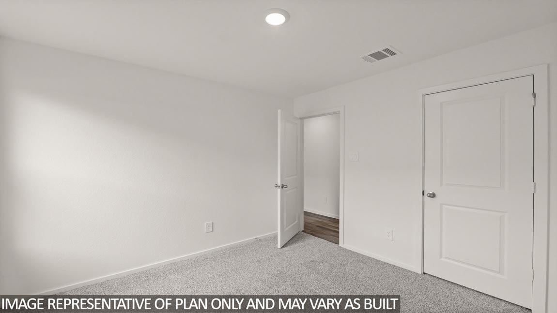Secondary bedroom with carpet flooring