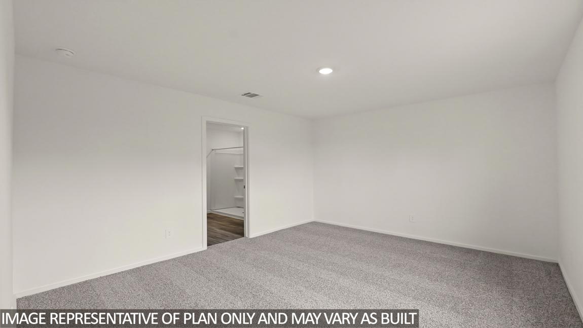 Primary bedroom with carpet flooring