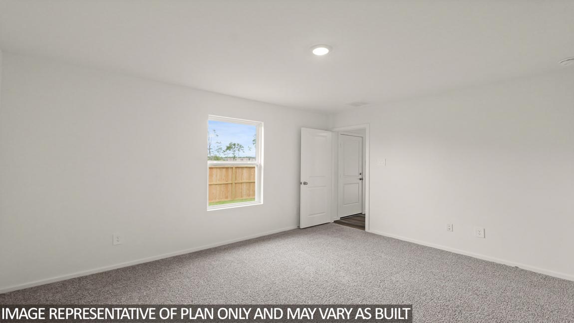 Primary bedroom with carpet flooring