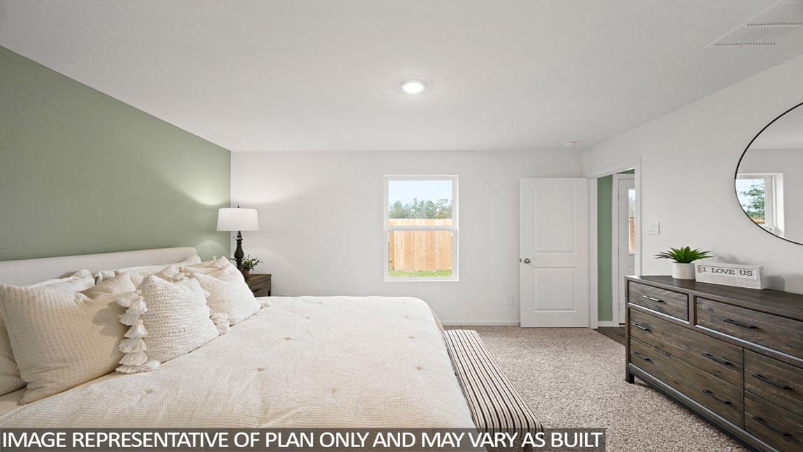 Primary bedroom with carpet flooring