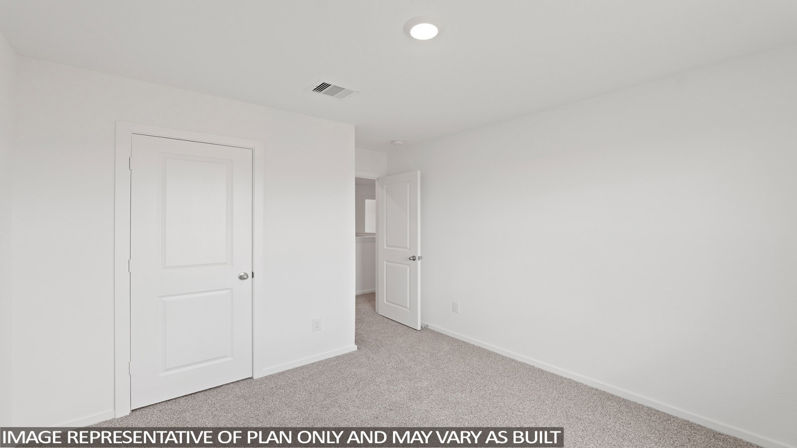 Secondary bedroom with carpet flooring