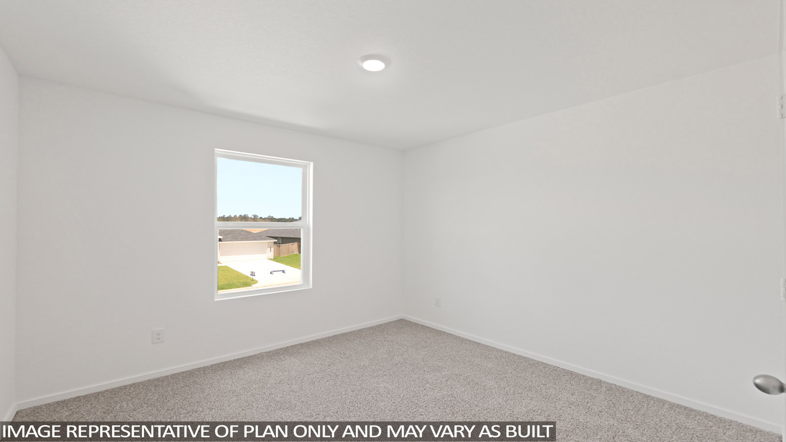 Secondary bedroom with carpet flooring