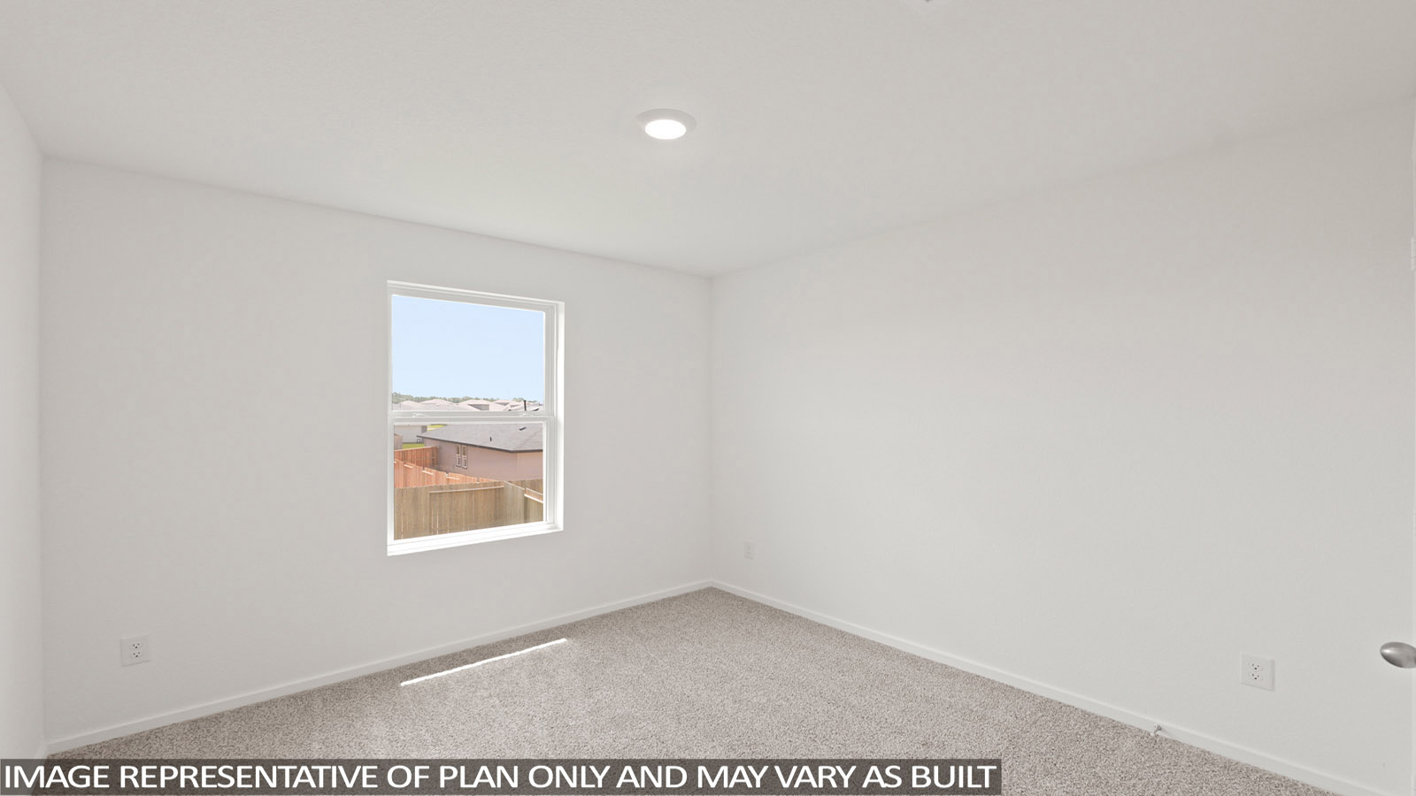 Secondary bedroom with carpet flooring