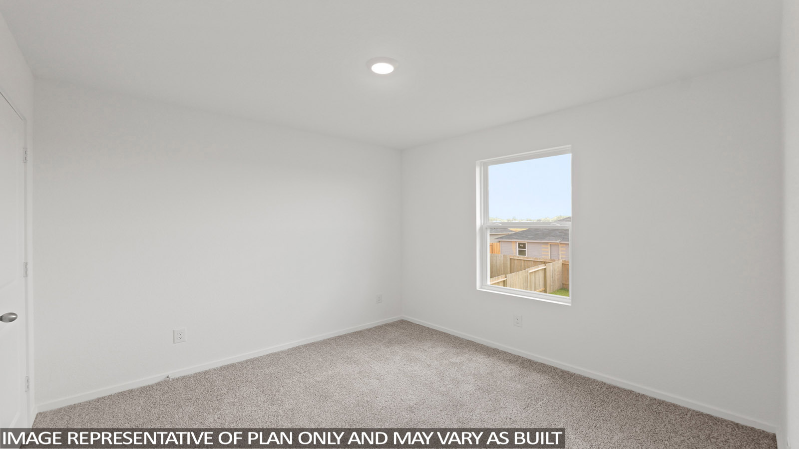 Secondary bedroom with carpet flooring
