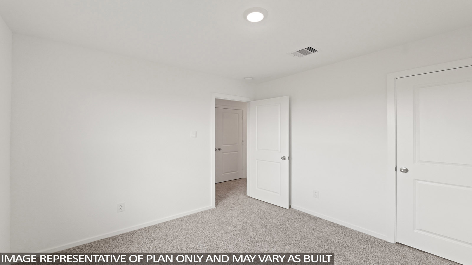 Secondary bedroom with carpet flooring
