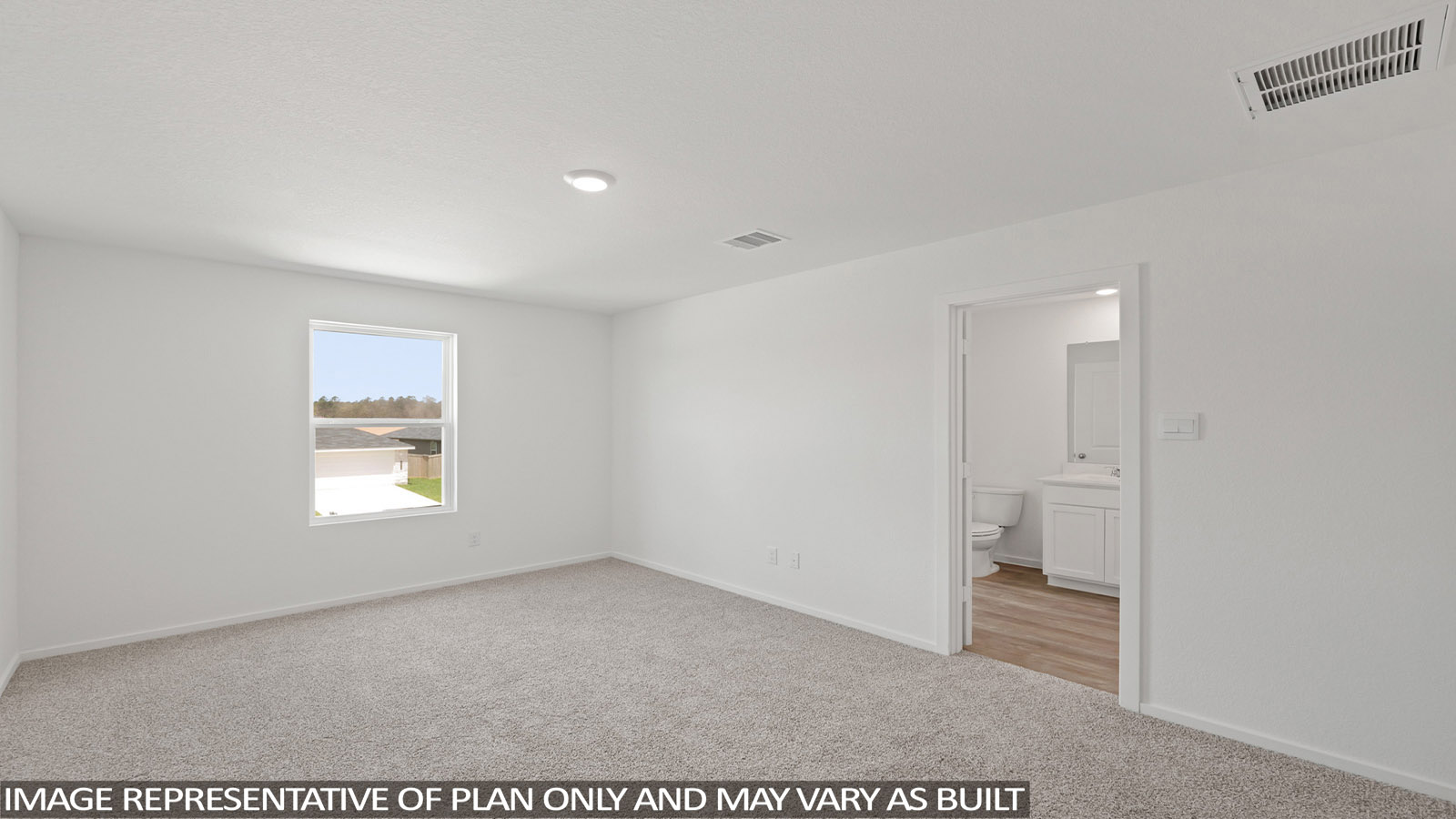 Primary bedroom with carpet flooring