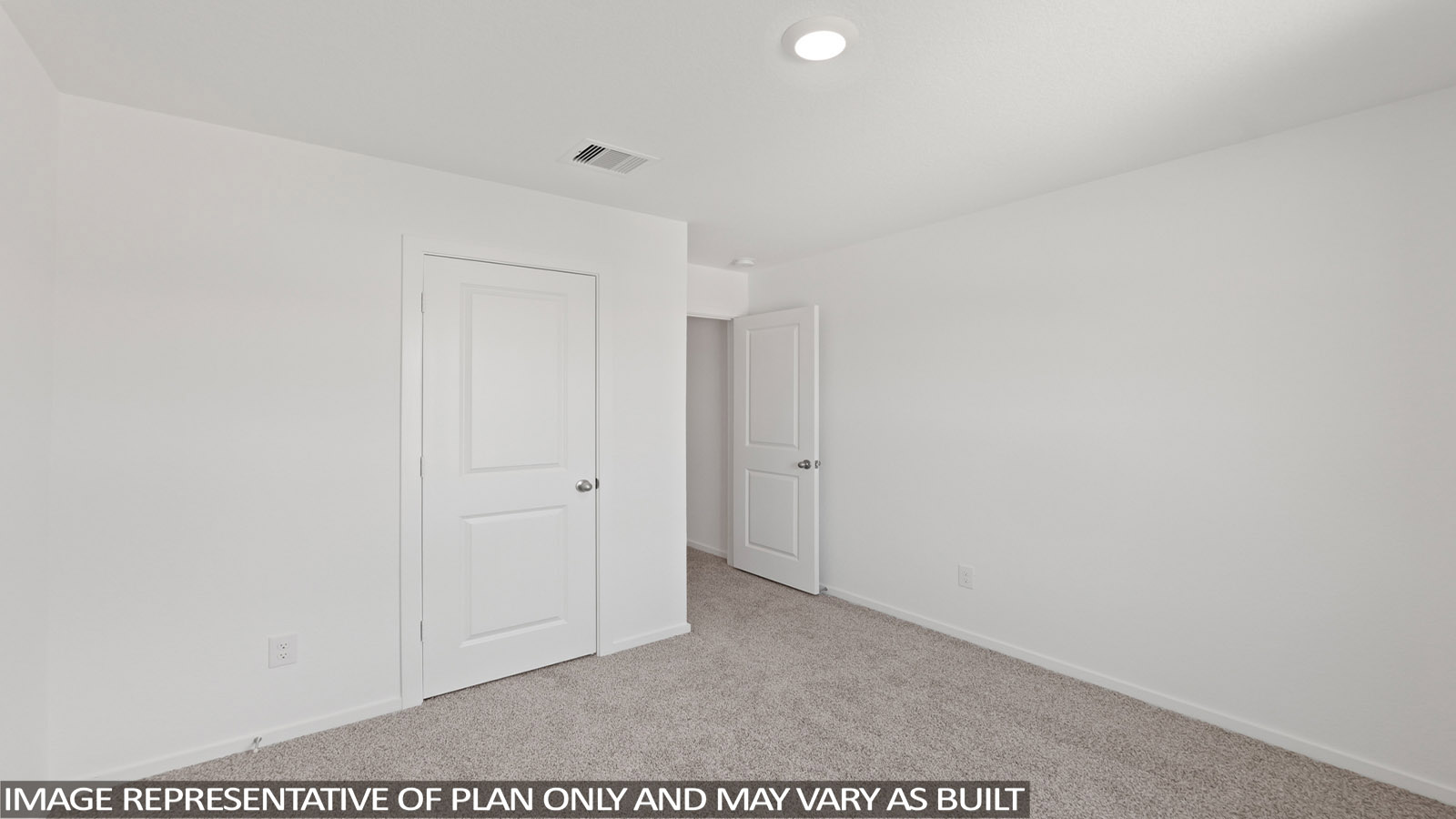 Secondary bedroom with carpet flooring