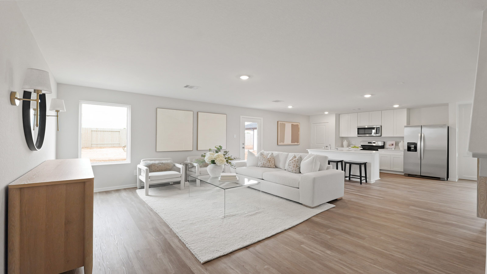 Open concept living and dining area with vinyl flooring and bright windows.