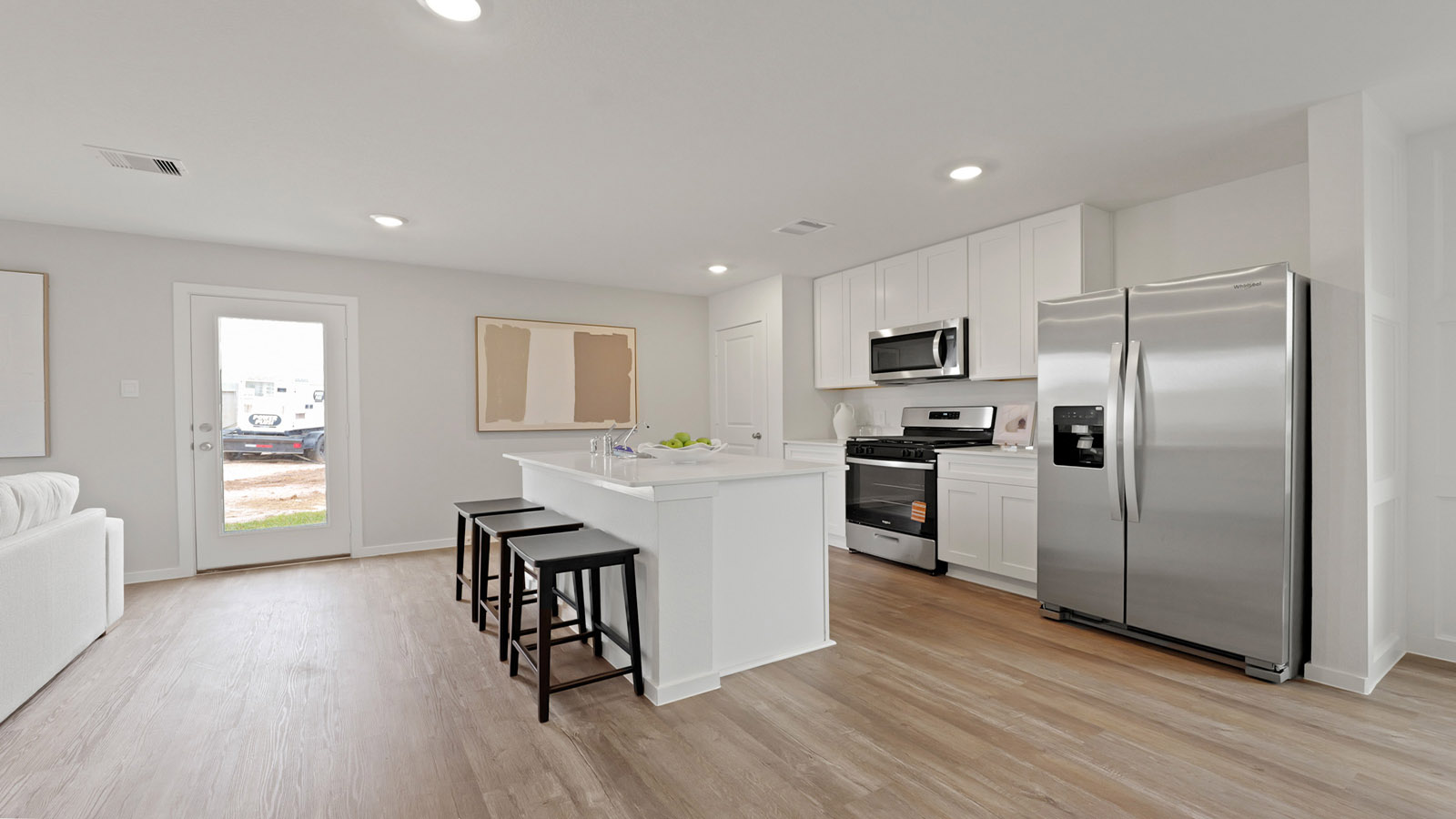 Kitchen with an island and stainless-steel appliances.