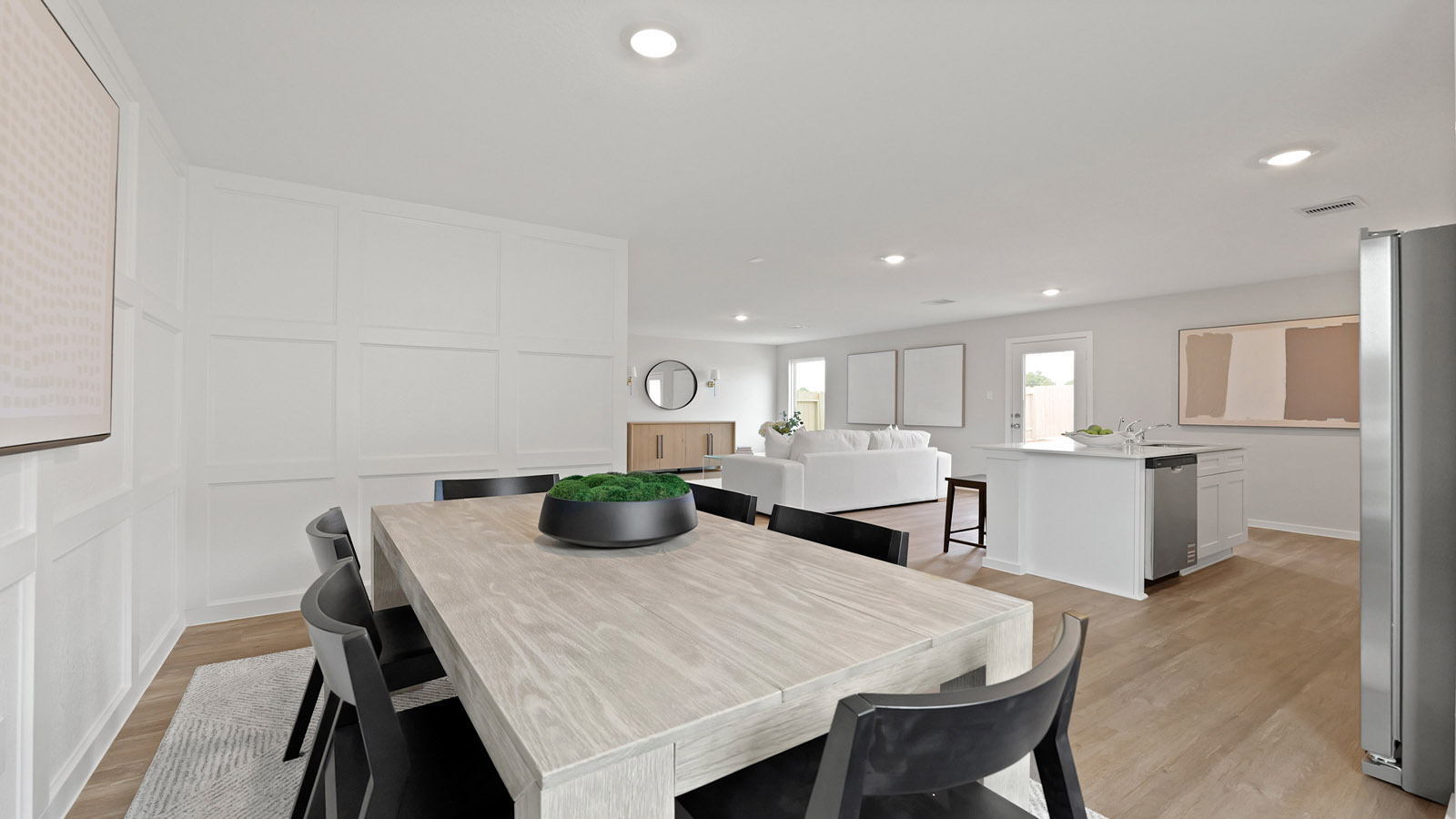 Dining area with vinyl flooring and a bright window.