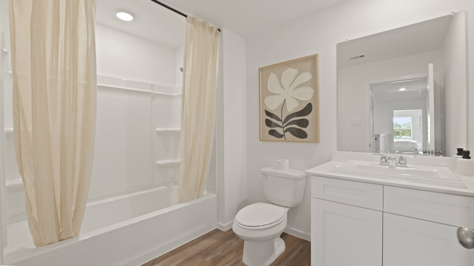 Secondary bathroom with a tile tub/shower combo and vinyl flooring.