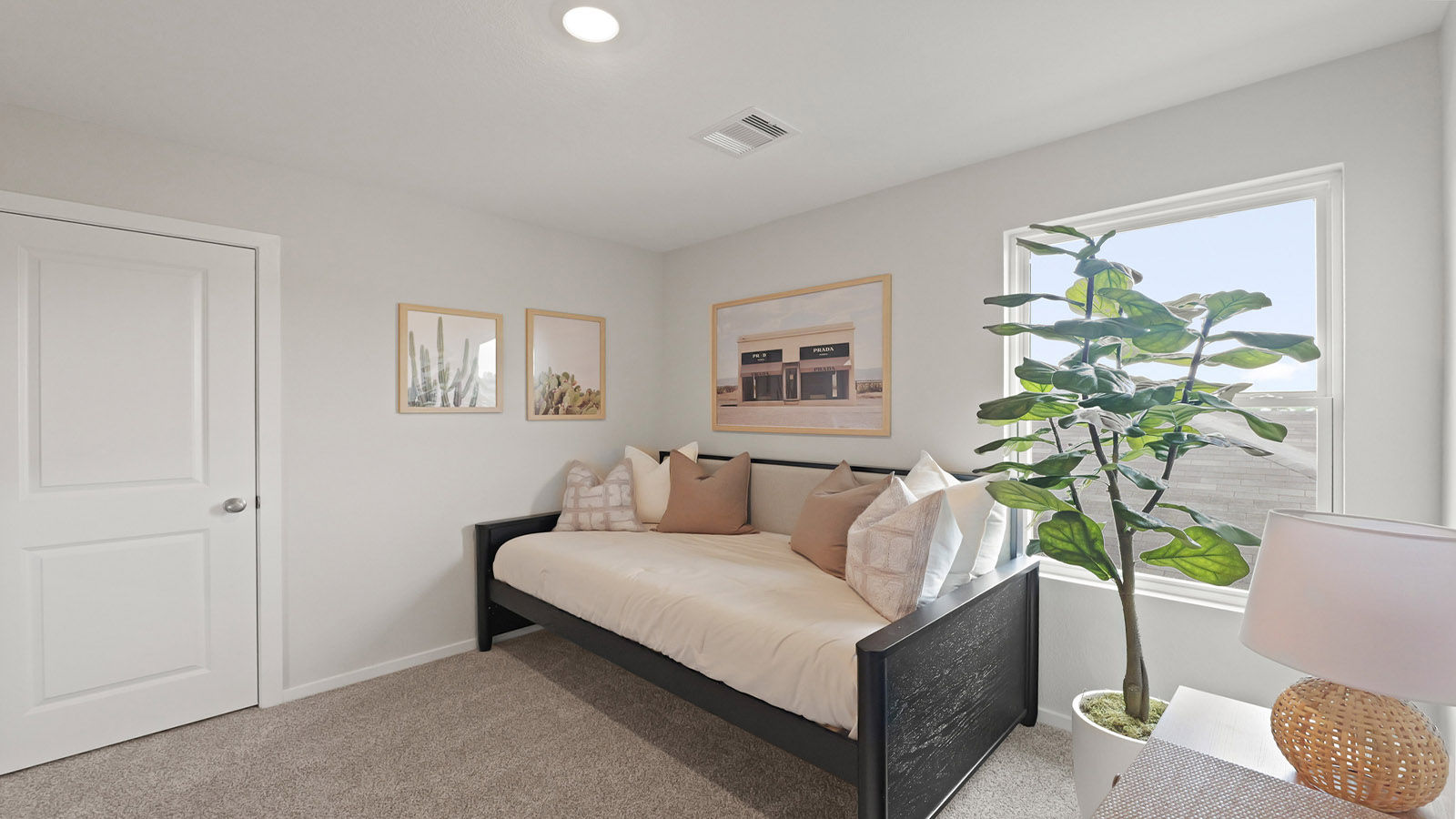 Secondary bedroom with carpet flooring, a bright window, and a tall closet.