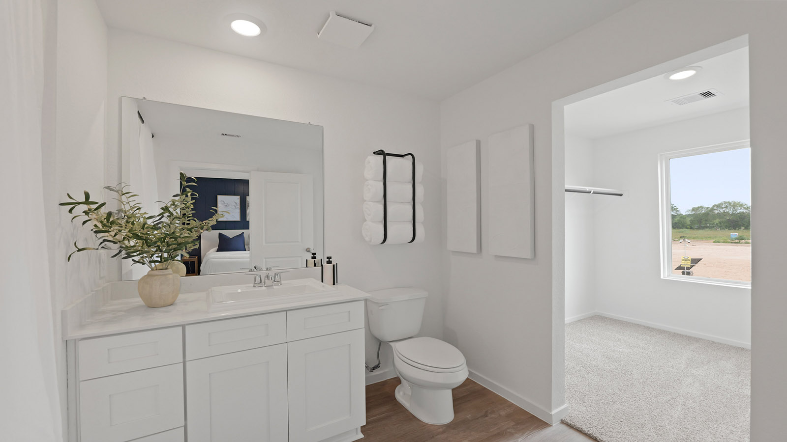 Primary bathroom with a standing shower and vinyl flooring.