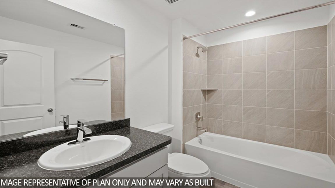 Secondary bathroom with a tile tub/shower combo.