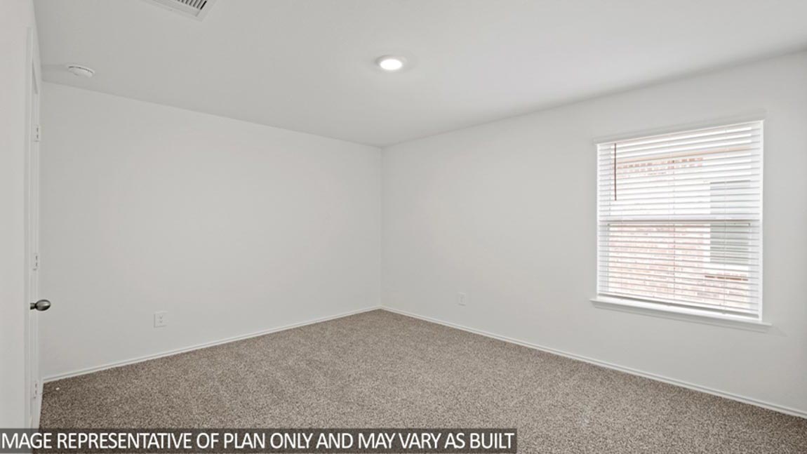 Secondary bedroom with carpet flooring and a bright window.
