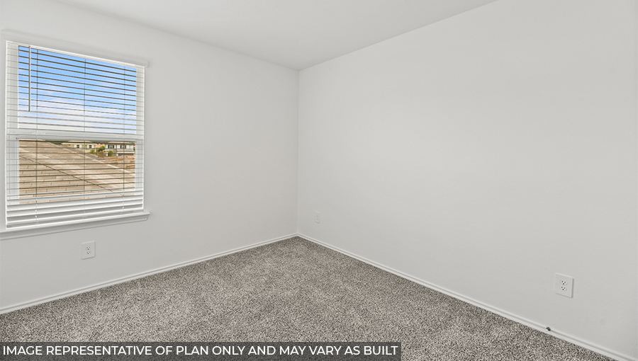 Secondary bedroom with carpet flooring